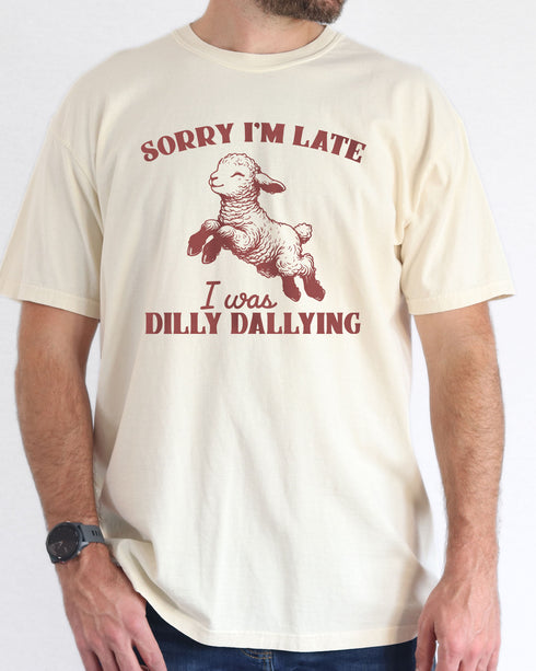 Man wearing natural color shirt with 'Sorry I'm Late I Was Dilly Dallying' graphic design